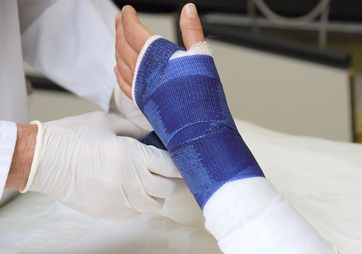 A person having a cast put on their arm
