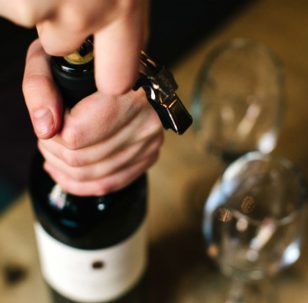 Wine bottles in a wine collection being uncorked