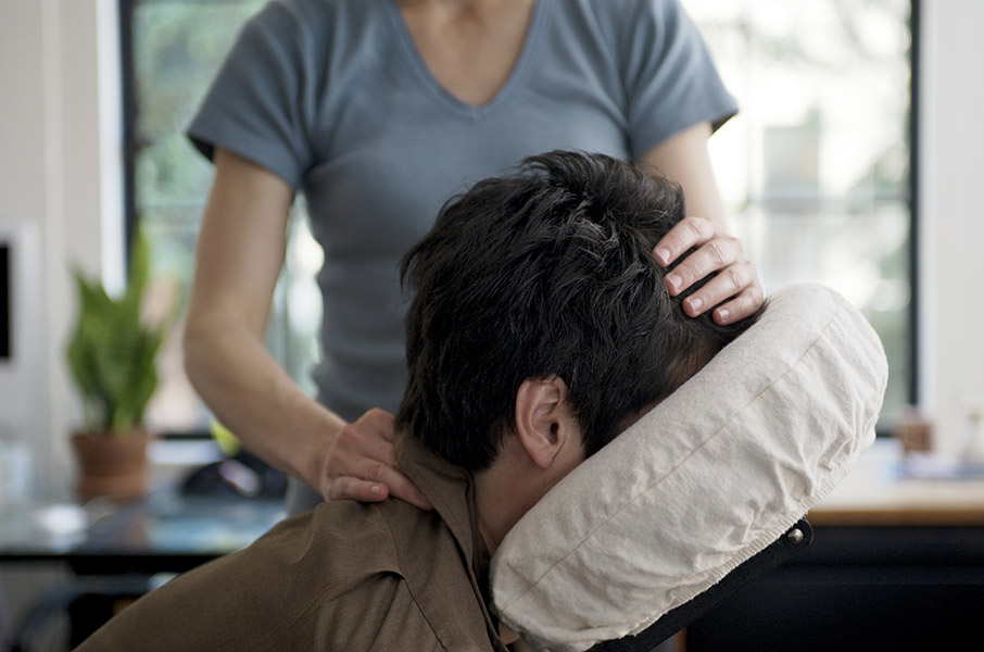 A person receiving a massage from a professional