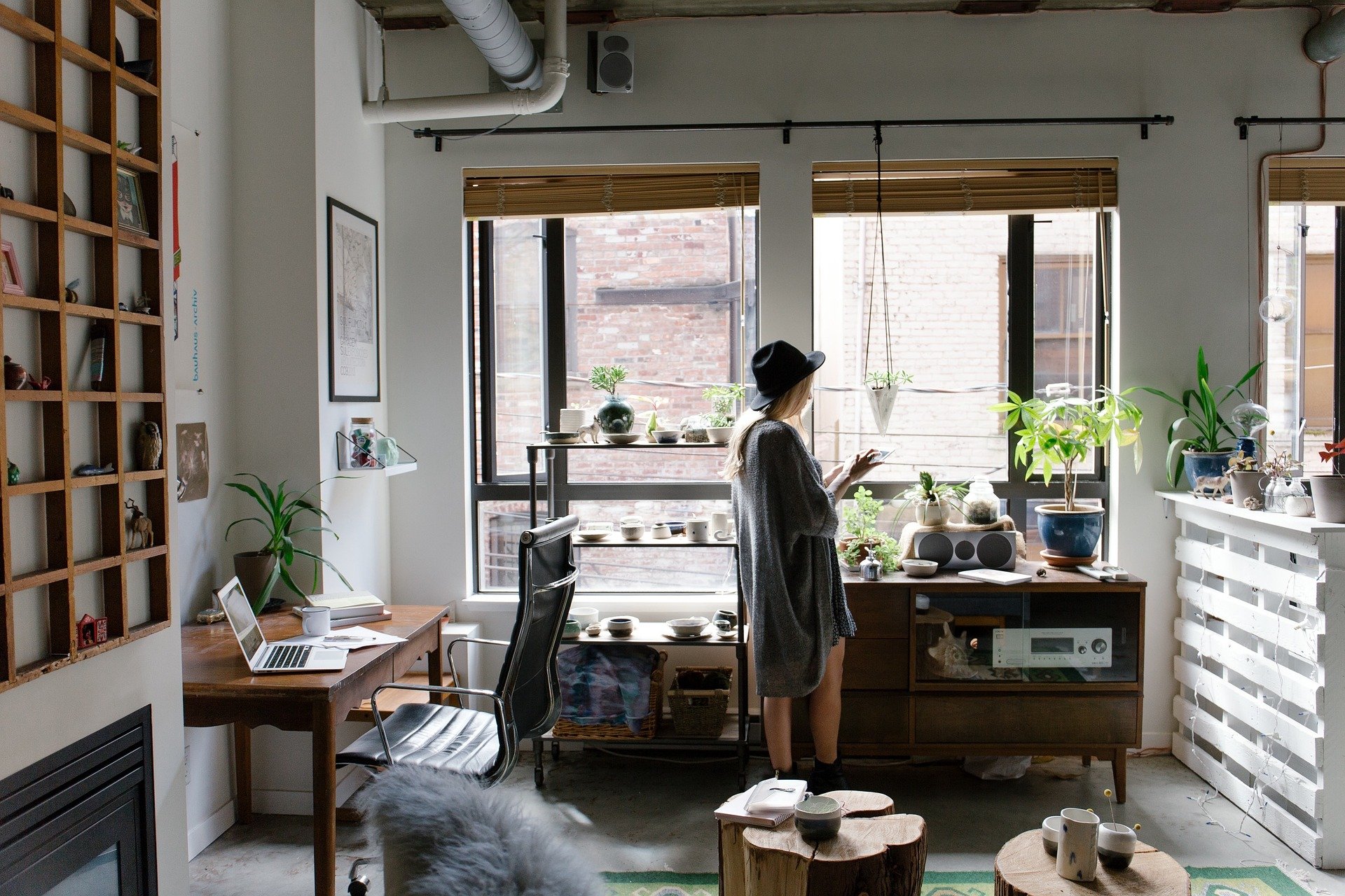 A woman facing the window in her living room