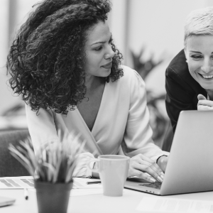 women talking at laptop