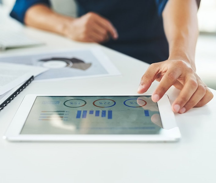 A consultant looking at charts on their tablet