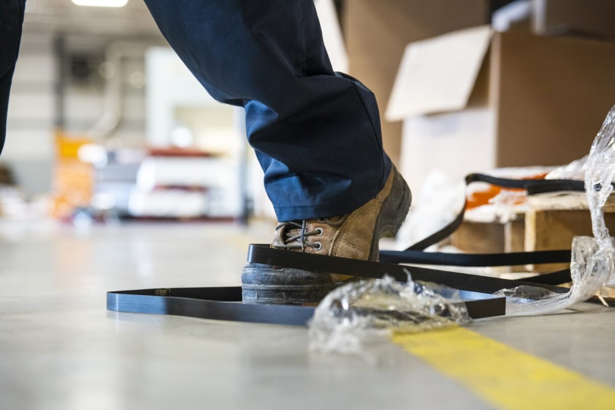 Man in warehouse about to trip over wiring