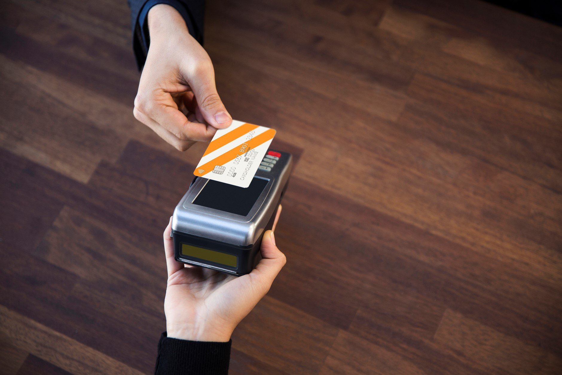 Person with card reader taking card contactless payment