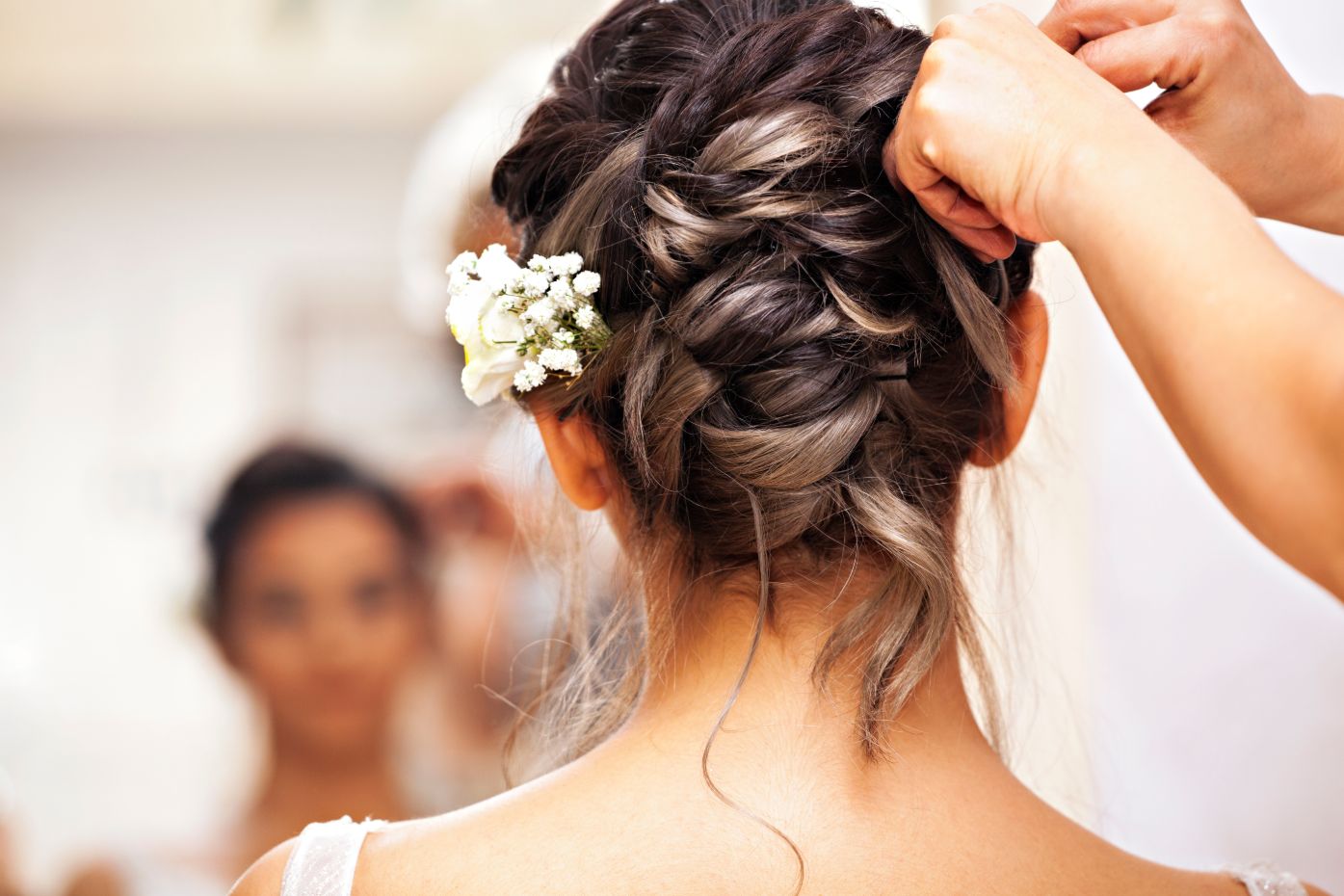 hair stylist plaiting hair