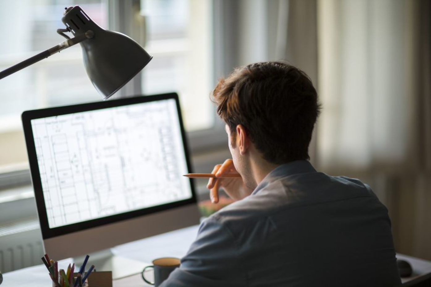 man working at a home office desk