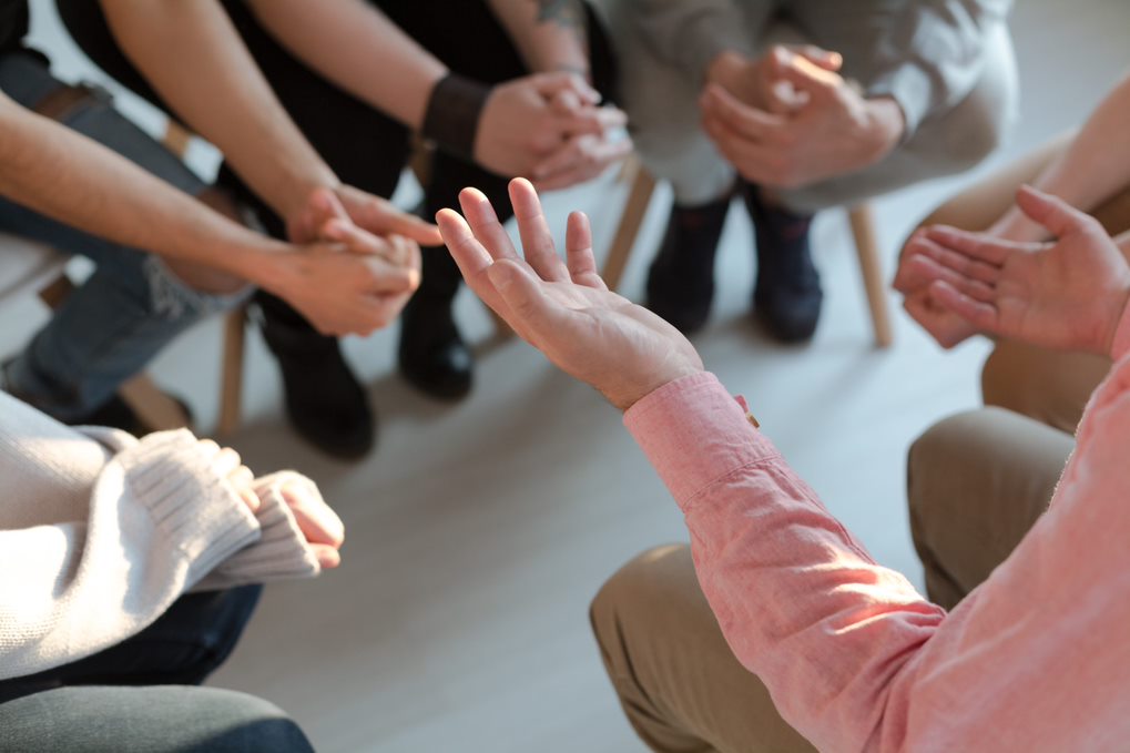 conversing people sitting in a circle