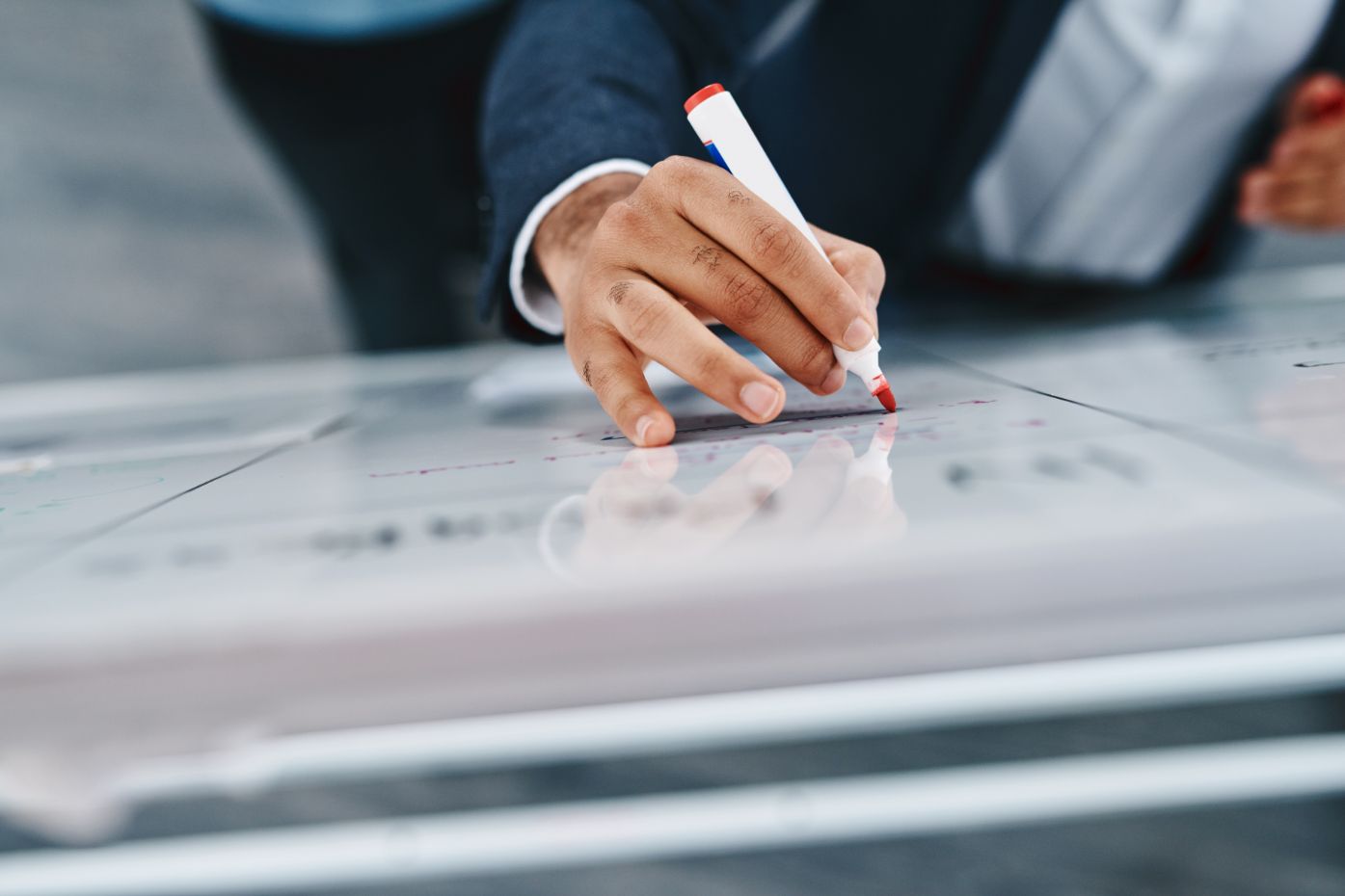 person drawing on whiteboard