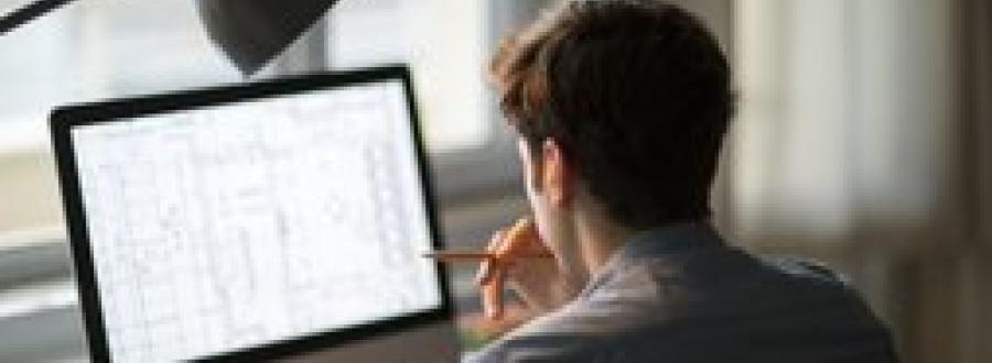 man working on a computer at home