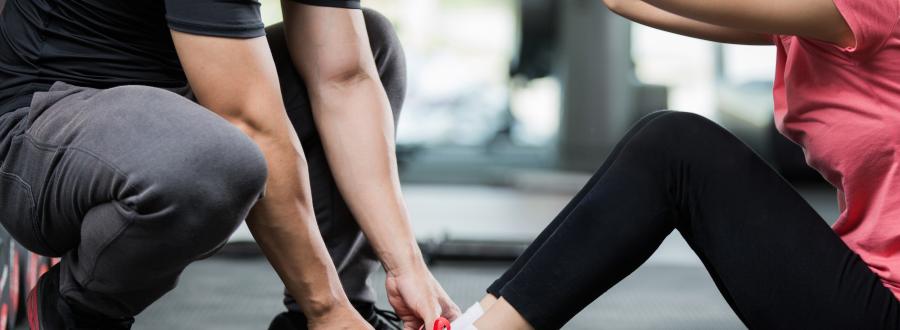 image showing personal trainer guiding client in gym