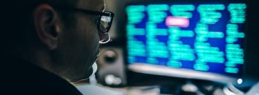 Man looking at a screen with data