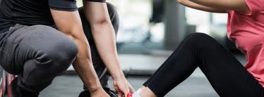 image showing personal trainer guiding client in gym