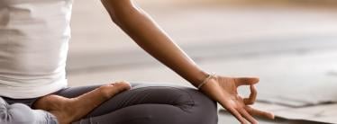 woman sitting on mat in yoga pose