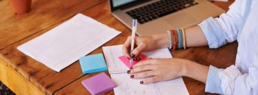 image showing woman writing on notepad