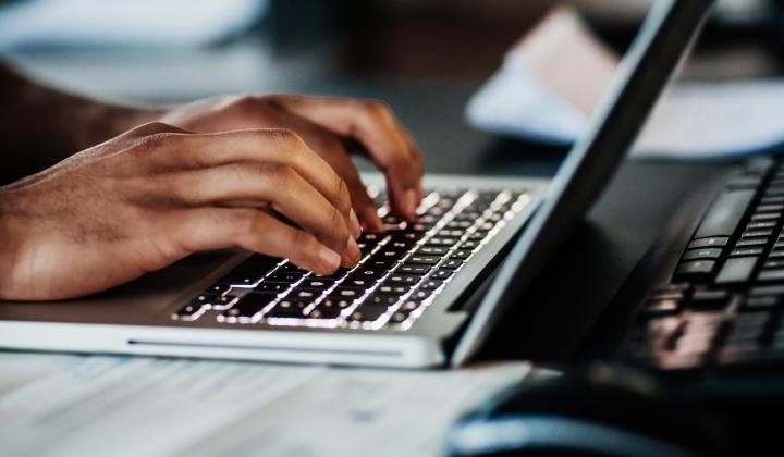 A person typing on a laptop