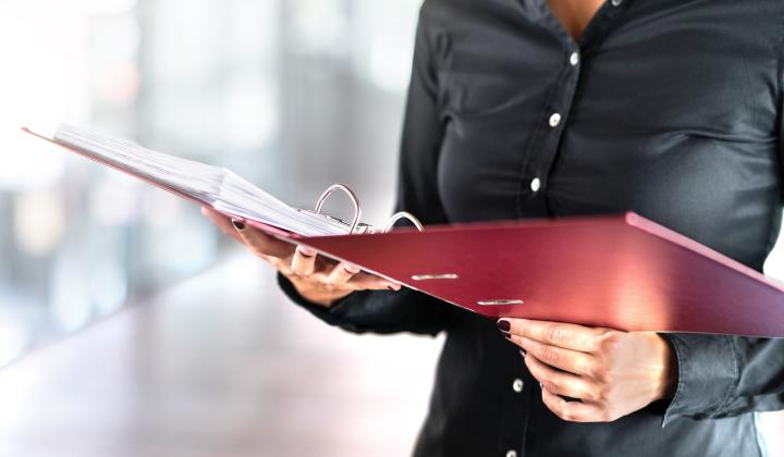 woman with red file and paper