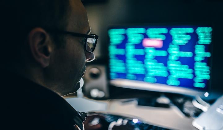 Man looking at a screen with data