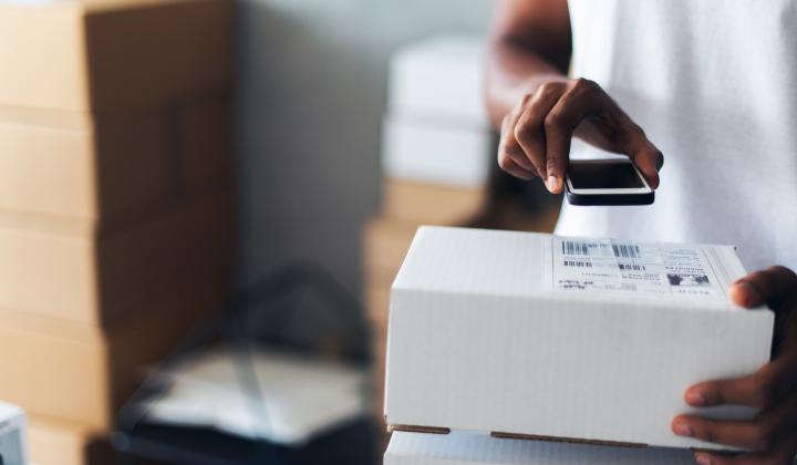 business owner scanning parcels using technology