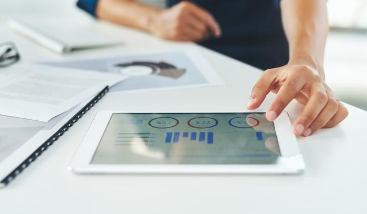 tablet showing financial data on desk