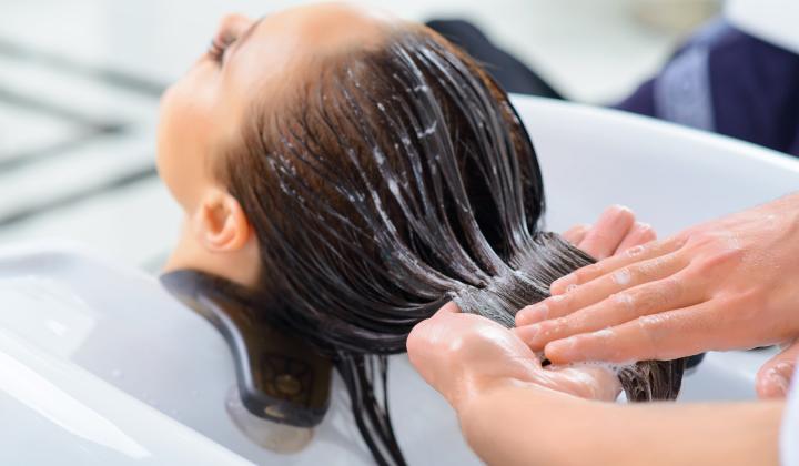 A woman getting her hair washed