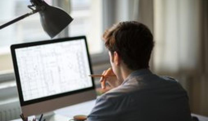 man working on a computer at home