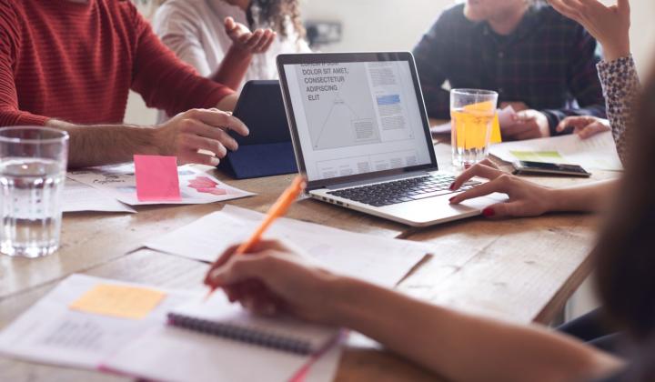 image showing group of people gathered with laptops in coworking space