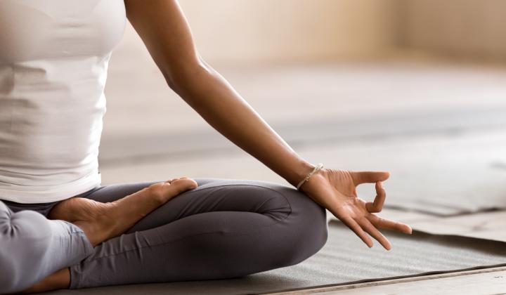 woman sitting on mat in yoga pose