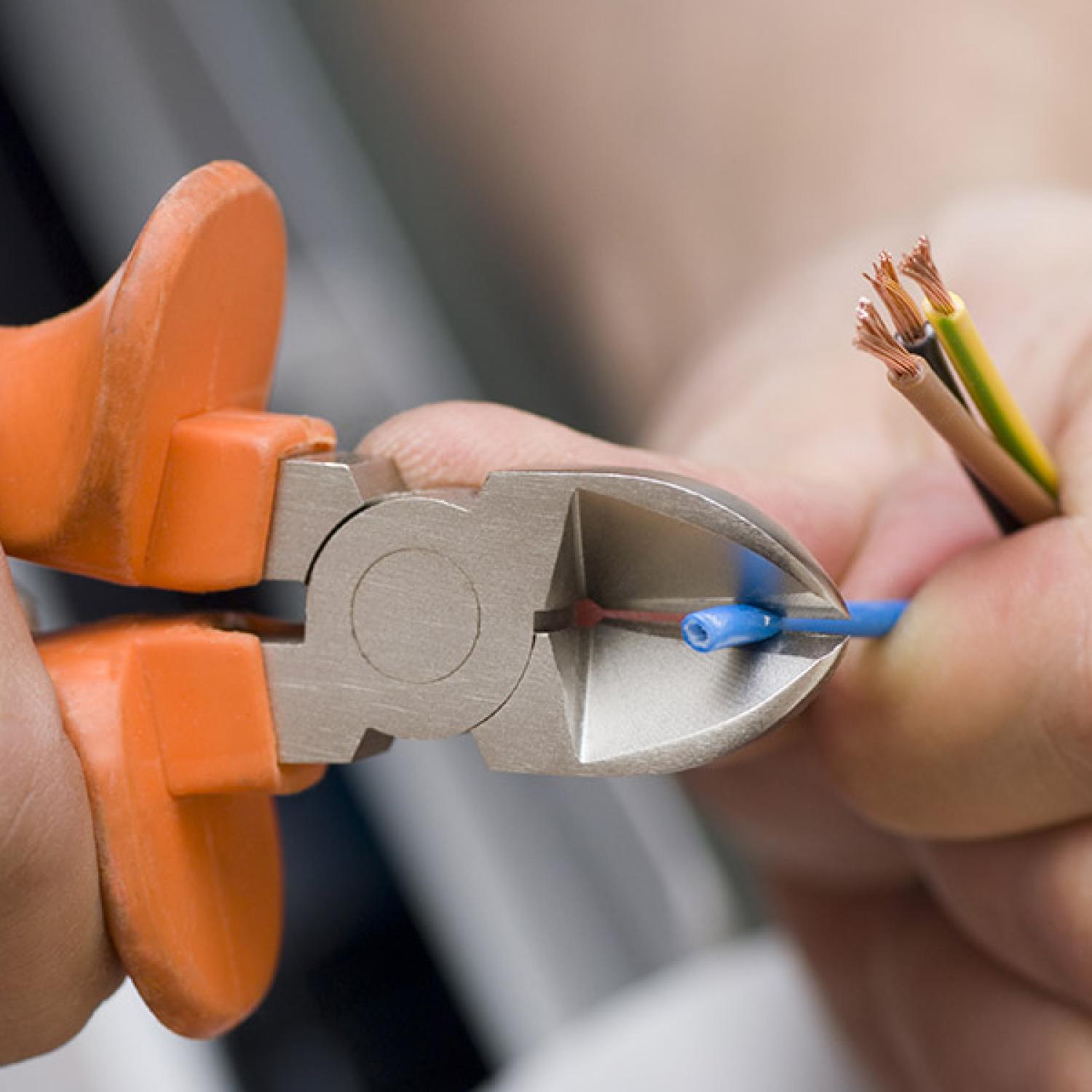 An electrician cutting wire