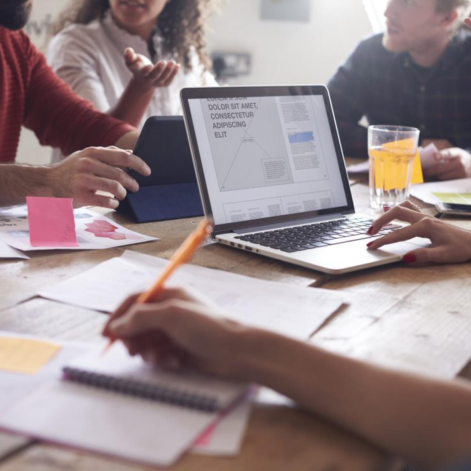 young professionals hot desk to work collaboratively