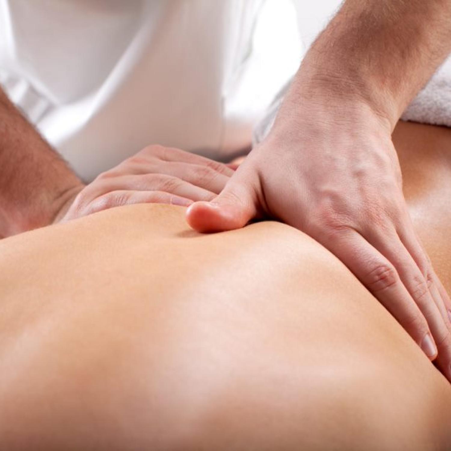 therapist performing massage on bare back