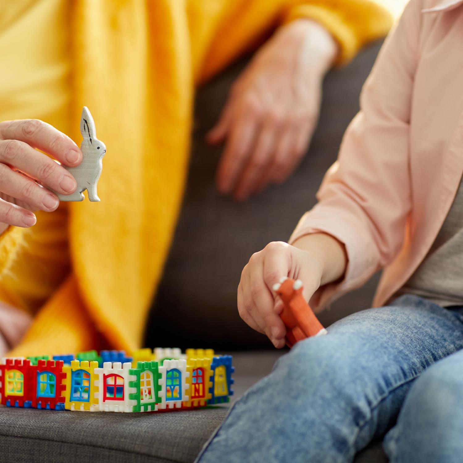 Woman and child sat playing with toys