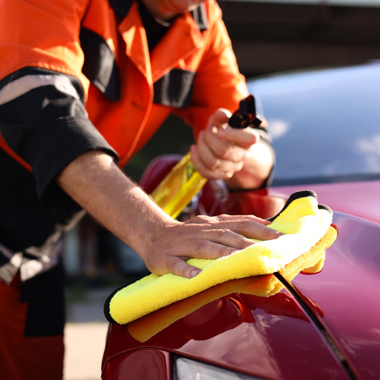 A person cleaning a car