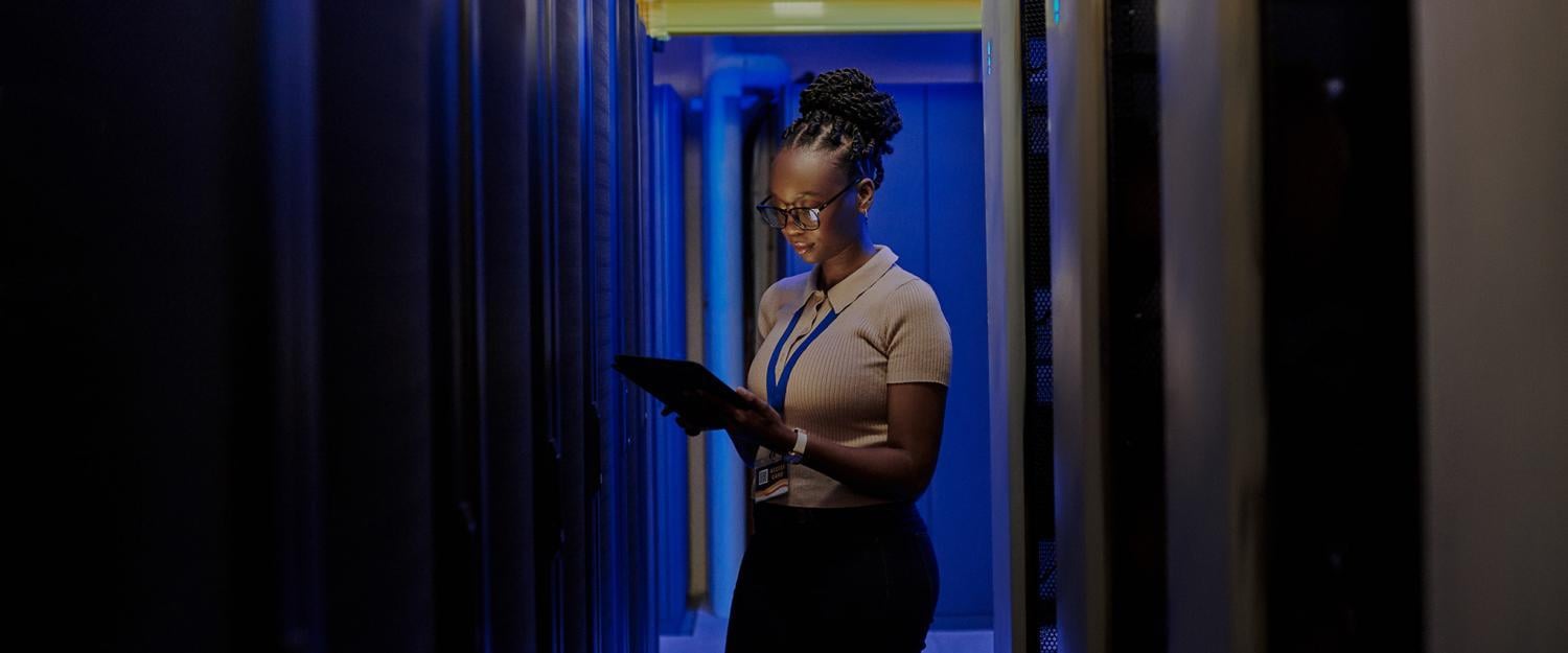 image showing business woman holding laptop in dark room