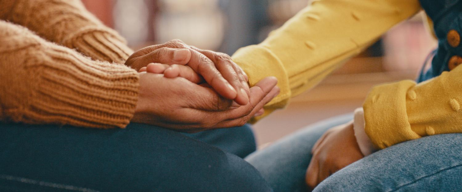 Two hands holding each other