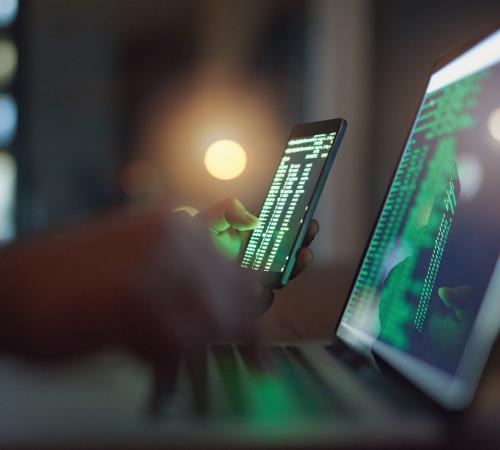 Code on a laptop and mobile phone screen