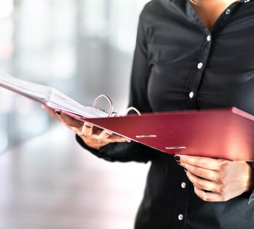 woman with red file and paper