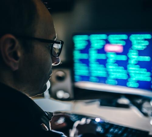 Man looking at a screen with data