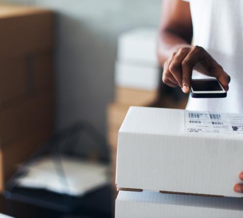business owner scanning parcels using technology