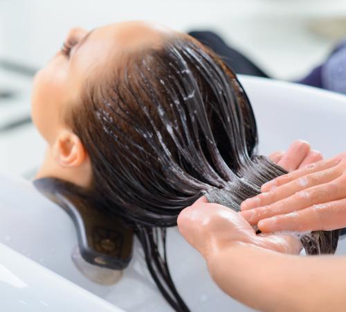 A woman getting her hair washed