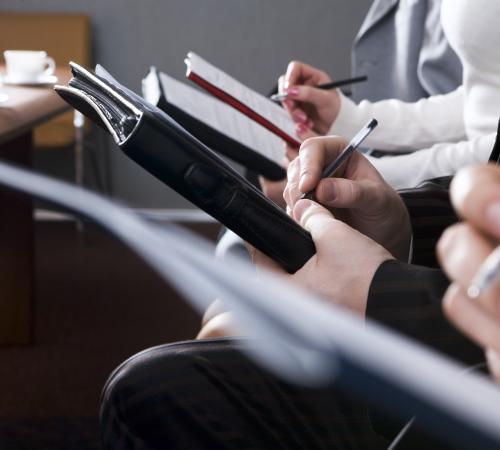 meeting with people writing notes on paper