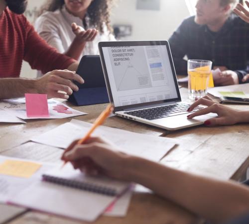 young professionals hot desk to work collaboratively