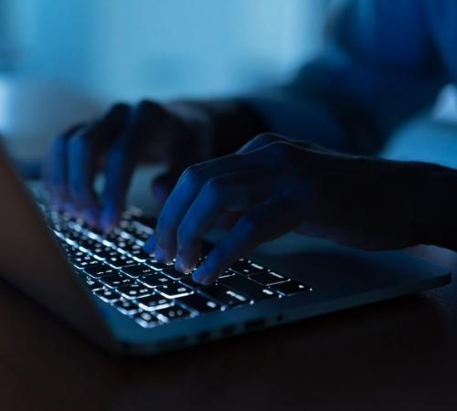 entrepreneur works at a laptop late at night