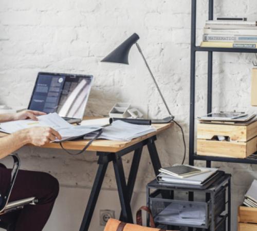 home office wooden desk shelves laptop