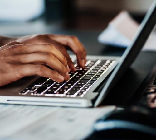typing at laptop