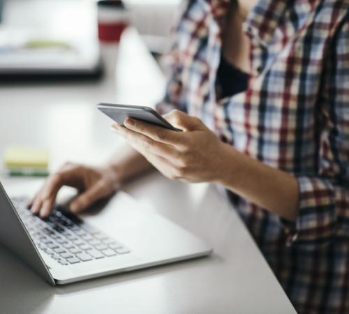 Person Working with Laptop and Mobile Phone