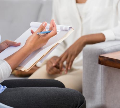 reflexology patient and practitioner in consultation