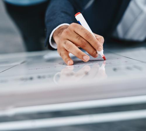 man writing on white board