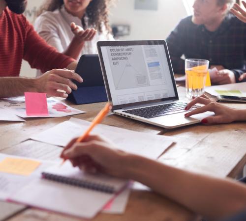 image showing group of people gathered with laptops in coworking space
