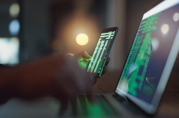 Code on a laptop and mobile phone screen