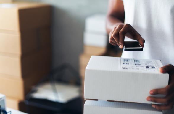 business owner scanning parcels using technology